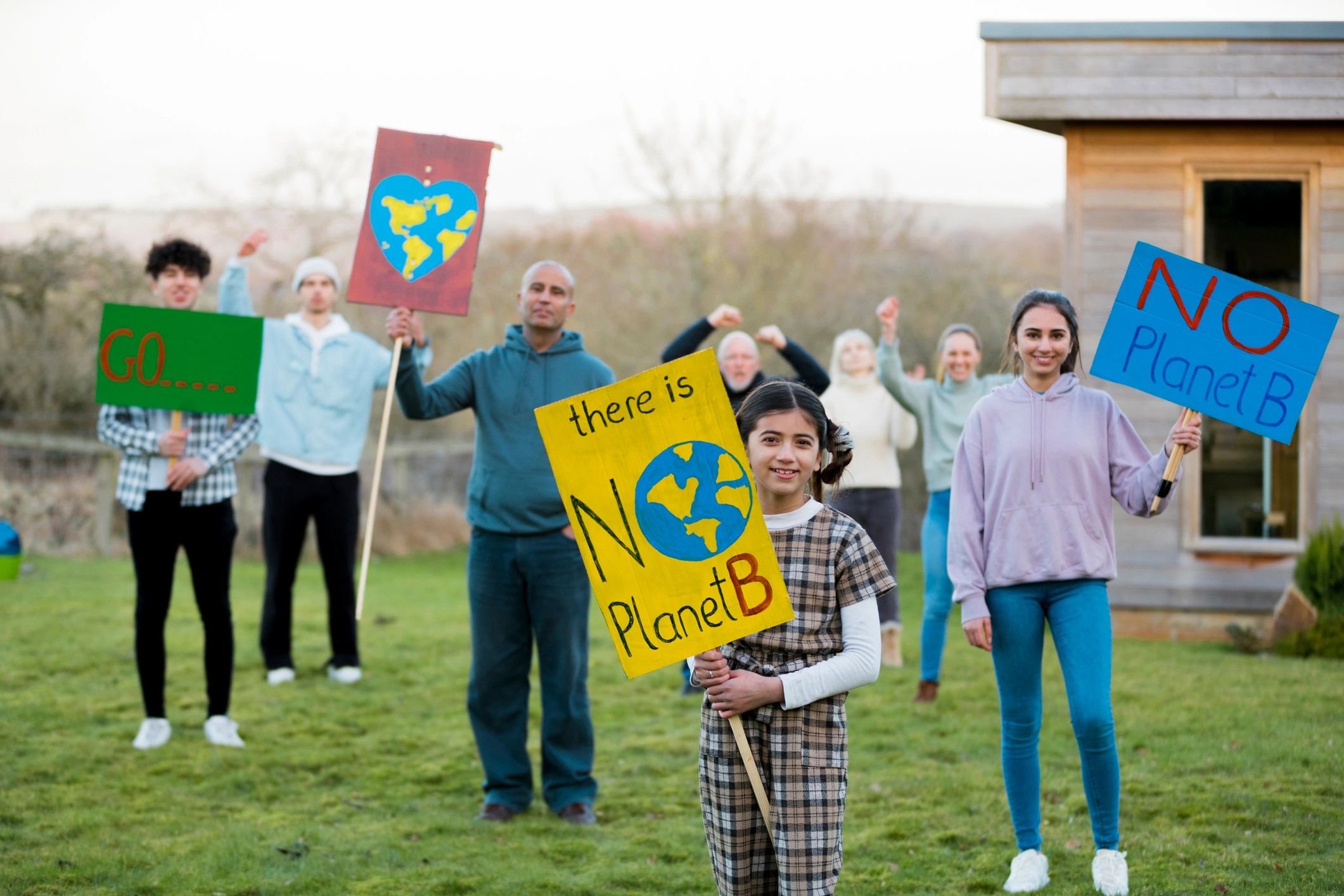 People holding protest signs outdoors