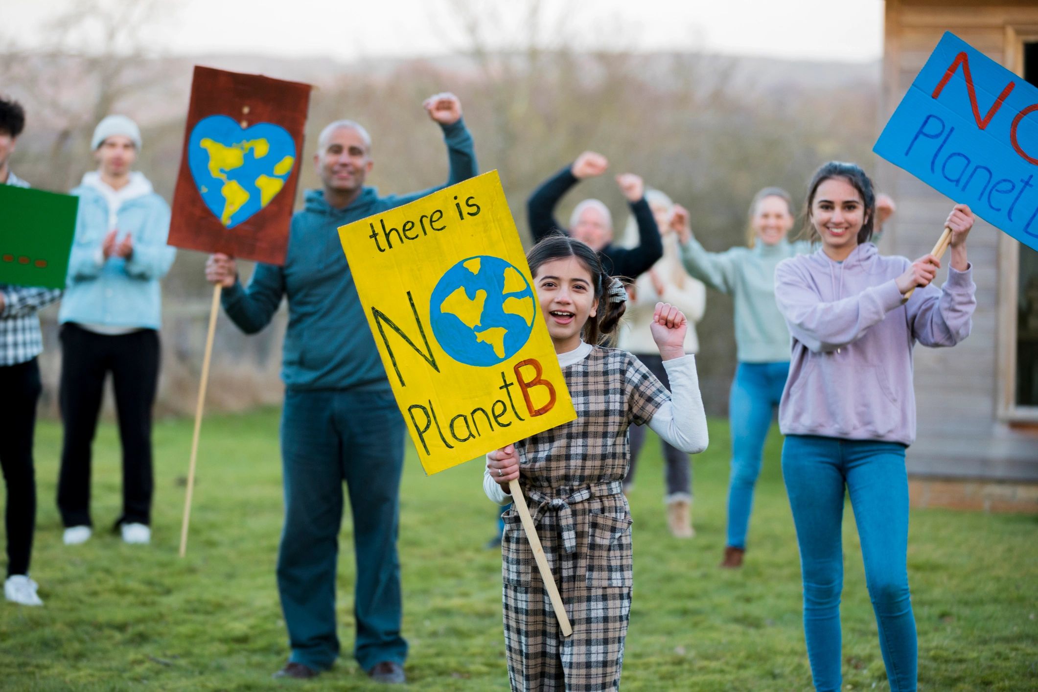 People holding advocacy signs outdoors