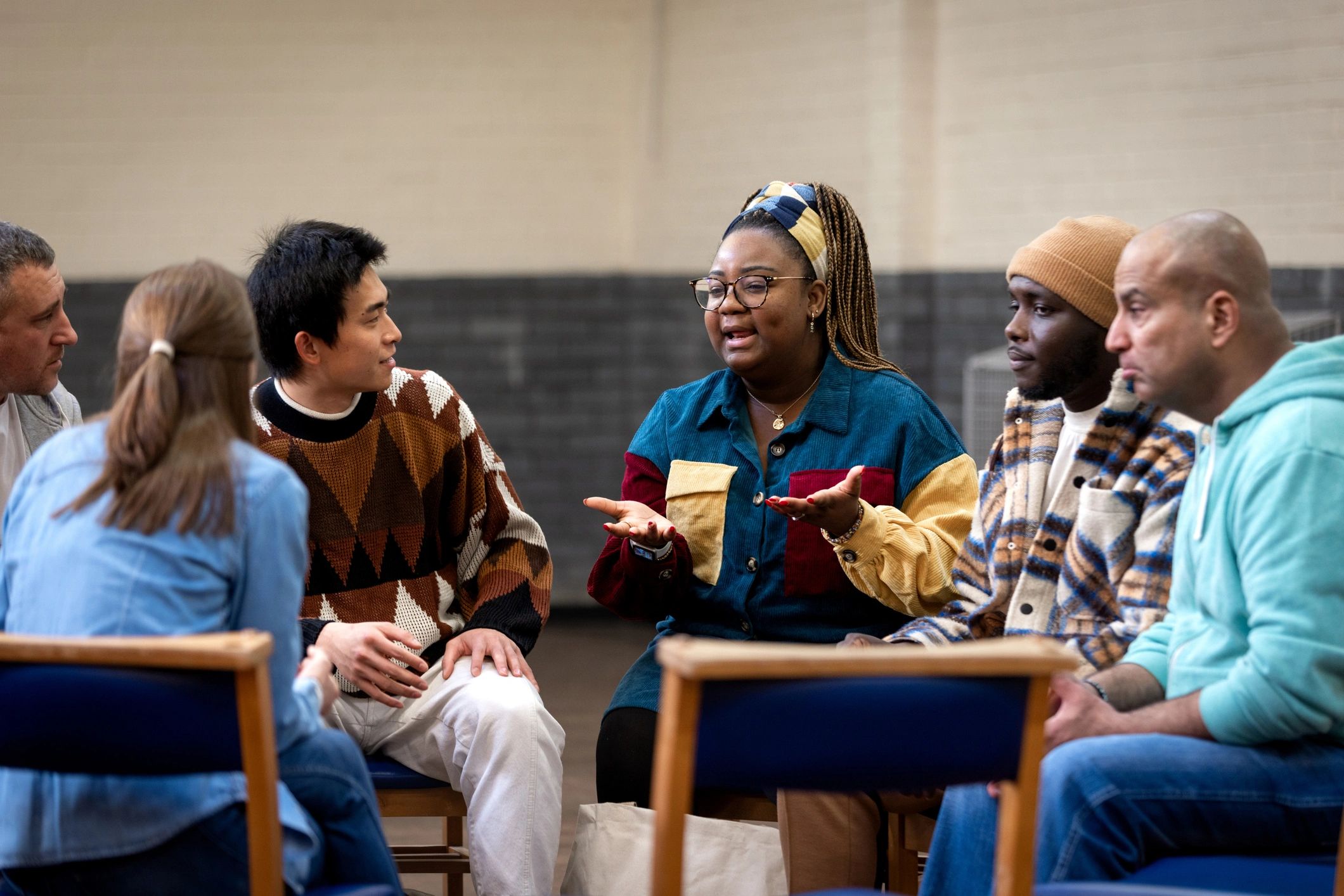 Community members in discussion at a meeting